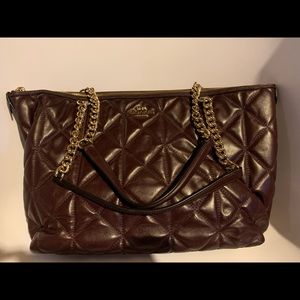 Deep burgundy brown quilted Coach bag.